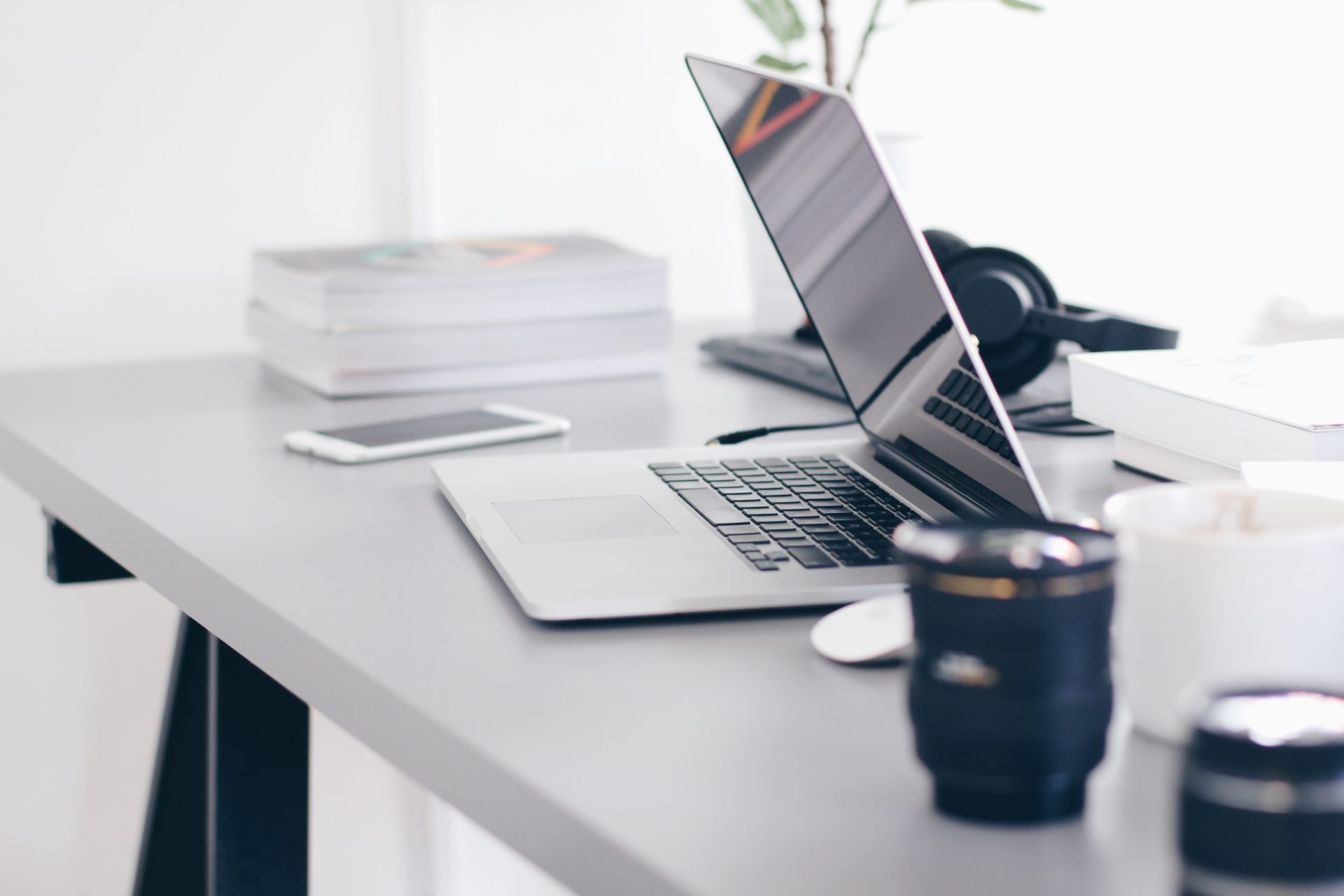 A desk with a laptop computer sitting on top of a table